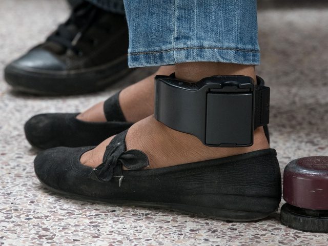TOPSHOT - An ankle monitor is seen on a migrant woman from El Salvador, recently released