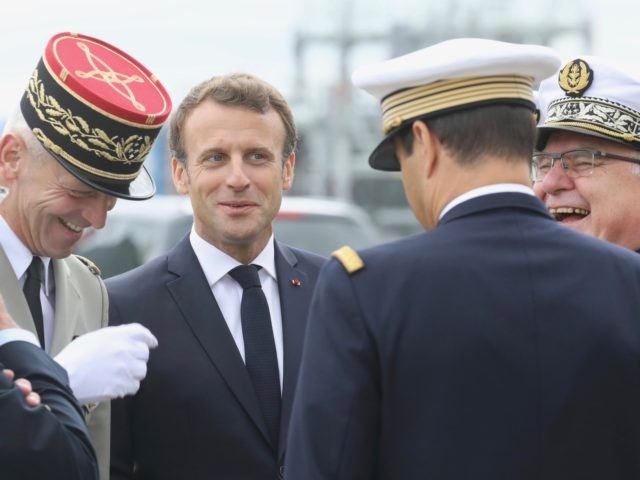 French President Emmanuel Macron (C) meets with French army chief of staff General Francois Lecointre (L), French President's personal Chief of Military Staff, Admiral Bernard Rogel (R) and other military officials before the official launch of the new French nuclear submarine "Suffren" built by Naval Group at the French naval …