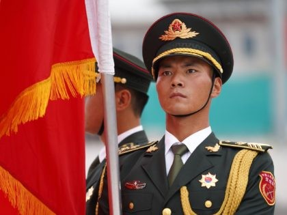 BEIJING, CHINA - SEPTEMBER 11: A soldier holds a flag and stands in preparation for the welcoming ceremony of the meeting between Chinese President Xi Jinping and Kazakh President Kassym Jomart Tokayev (not pictured) on September 11, 2019 at the Great Hall of the People, Beijing, China. (Photo by Andrea …
