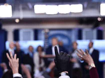 Reporters ask questions as US President Donald Trump speaks during a press briefing at the