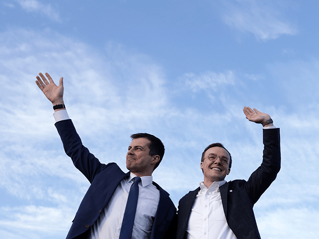 Democratic presidential candidate former South Bend, Indiana Mayor Pete Buttigieg and his husband Chasten Buttigieg wave during a campaign town hall event at Washington Liberty High School February 23, 2020 in Arlington, Virginia. Buttigieg held the event in Virginia to campaign for the upcoming Super Tuesday primaries. (Photo by Alex …