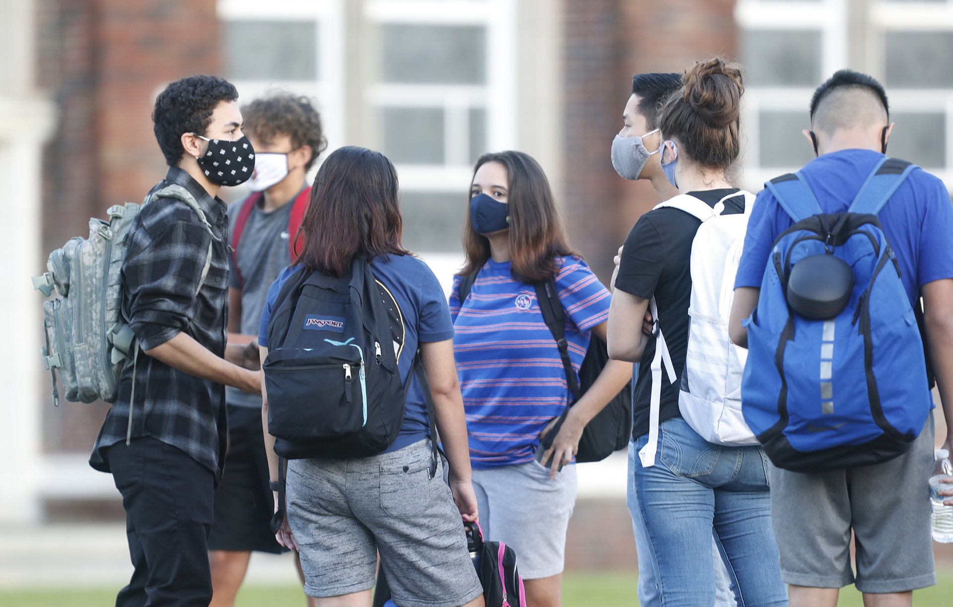 TAMPA, FL - AUGUST 31: Students at Hillsborough High School wait in line to have temperature checked before entering the building on August 31, 2020 in Tampa, Florida. The Hillsborough County Schools District gives their students the in-class learning option amid the coronavirus pandemic. (Photo by Octavio Jones/Getty Images)