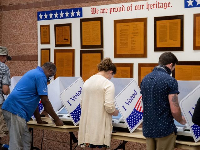 TOPSHOT - Voters cast their ballots in the voting booths at the early vote location at the Charleston Coliseum and Convention Center in North Charleston, South Carolina on October 16, 2020. - Many states across the country have seen record turnout for early voting for the 2020 election. (Photo by …