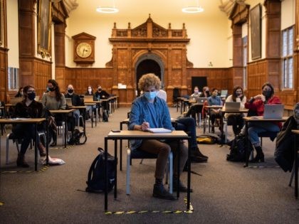 OXFORD, ENGLAND - NOVEMBER 24: Masked students sit in a socially distanced class in the Examination Schools of the University of Oxford on November 24, 2020 in Oxford, England. The university concluded its Michaelmas term largely under England's nationwide lockdown that curtailed in-person instruction and suspended extracurricular events. Like other …