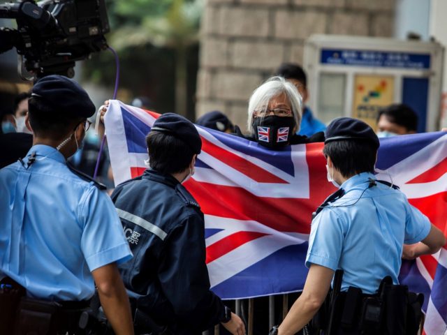 Alexandra Wong (C), an activist known as Grandma Wong, waves a British Union Jack flag out