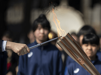 The Olympic torch is lit at the start of the second day of the Tokyo 2020 Olympic Games torch relay at Somanakamura Shrine in the town of Soma, Fukushima Prefecture on March 26, 2021. (Photo by CHARLY TRIBALLEAU / AFP) (Photo by CHARLY TRIBALLEAU/AFP via Getty Images)