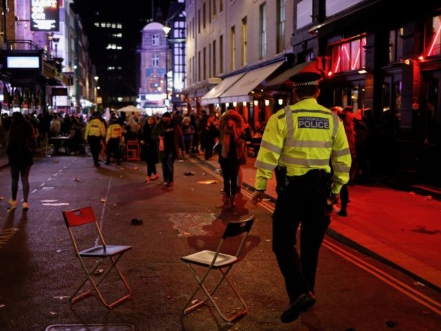 Police officers patrol the streets after a day where customers were able to drink at tables outside the pubs and bars in the Soho area of London, on April 12, 2021 after coronavirus restrictions were eased across the country in step two of the government's roadmap out of England's third …