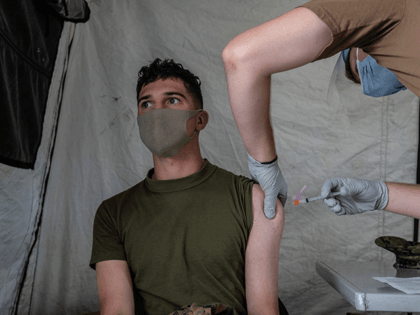 A United States Marine receives the Moderna coronavirus vaccine at Camp Foster on April 28