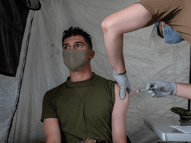 A United States Marine receives the Moderna coronavirus vaccine at Camp Foster on April 28, 2021 in Ginowan, Japan. A United States military vaccination program aiming to inoculate all service personnel and their families against Covid-19 coronavirus is under way on Japans southernmost island of Okinawa, home to around 30,000 US troops and one of the largest US Marine contingents outside of mainland USA. (Photo by Carl Court/Getty Images)