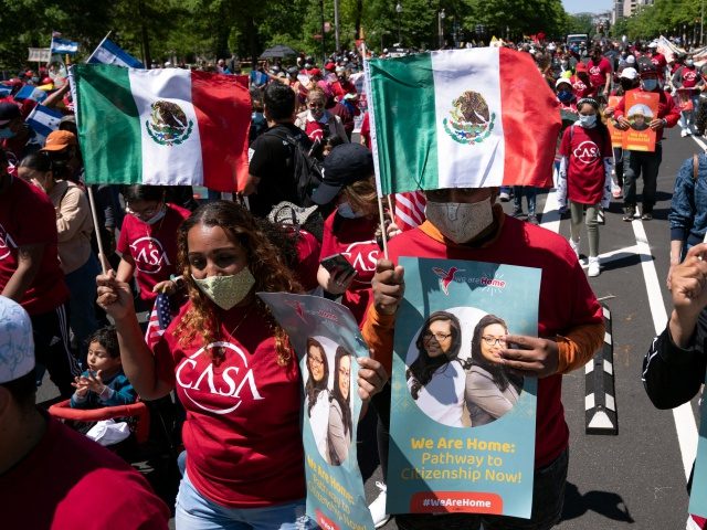 Immigration rights supporters march demanding citizenship for essential workers during a demonstration marking Mayday, in Washington DC, on May 1, 2021. (Photo by Jose Luis Magana / AFP) (Photo by JOSE LUIS MAGANA/AFP via Getty Images)