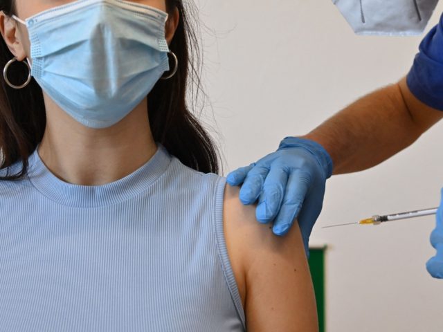 A woman is being vaccinated with the Pfizer-BioNTech vaccine at a Poliambulatorio Health Canter in the southern Italian Pelagie Island of Lampedusa on May 15, 2021. (Photo by Alberto PIZZOLI / AFP) (Photo by ALBERTO PIZZOLI/AFP via Getty Images)