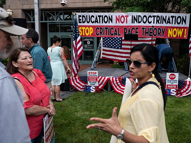 People talk before the start of a rally against "critical race theory" (CRT) being taught in schools at the Loudoun County Government center in Leesburg, Virginia on June 12, 2021. - "Are you ready to take back our schools?" Republican activist Patti Menders shouted at a rally opposing anti-racism teaching that critics like her say trains white children to see themselves as "oppressors." "Yes!", answered in unison the hundreds of demonstrators gathered this weekend near Washington to fight against "critical race theory," the latest battleground of America's ongoing culture wars. The term "critical race theory" defines a strand of thought that appeared in American law schools in the late 1970s and which looks at racism as a system, enabled by laws and institutions, rather than at the level of individual prejudices. But critics use it as a catch-all phrase that attacks teachers' efforts to confront dark episodes in American history, including slavery and segregation, as well as to tackle racist stereotypes. (Photo by ANDREW CABALLERO-REYNOLDS / AFP) (Photo by ANDREW CABALLERO-REYNOLDS/AFP via Getty Images)
