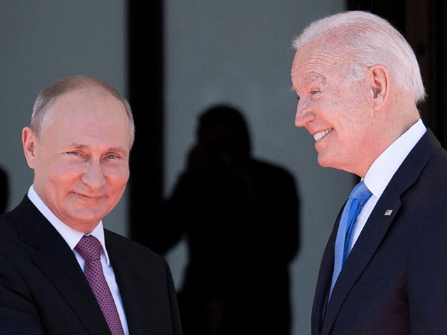 Russian President Vladimir Putin (L) shakes hands with US President Joe Biden prior to the