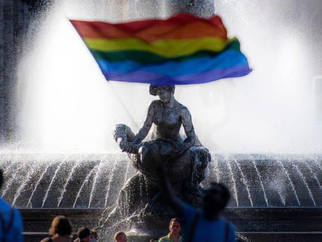 A participant holds a rainbow flag as people take part in the annual Pride March in Rome, on June 26, 2021. (Photo by Tiziana FABI / AFP) (Photo by TIZIANA FABI/AFP via Getty Images)