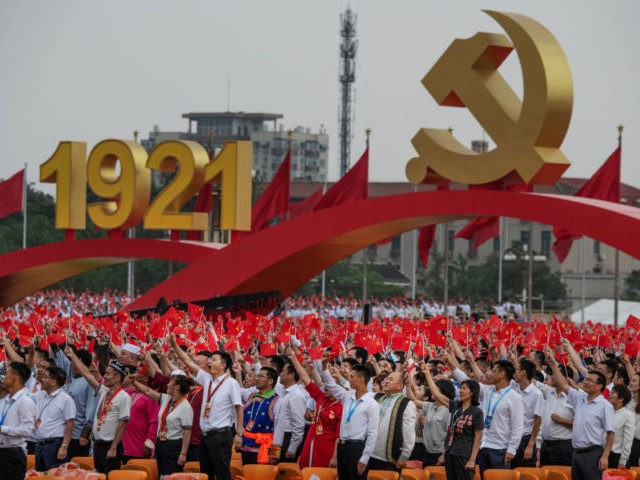 BEIJING, CHINA - JULY 01: Members of the audience stand and applaud Chinese President and Chairman of the Communist Party Xi Jinping, not seen, during his speech at a ceremony marking the 100th anniversary of the Communist Party at Tiananmen Square on July 1, 2021 in Beijing, China. (Photo by …