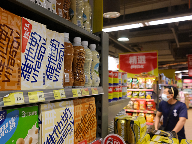 Soy milk drinks produced by local beverage brand Vitasoy (L) are displayed on a supermarke