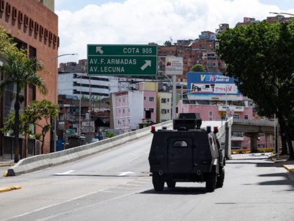 Members of the Special Actions Forces command (FAES) aboard an armored vehicle drive along a main avenue of Caracas during clashes against alleged members of a criminal gang in the surroundings of La Cota 905 neighborhood, on July 8, 2021. - A new clash between police and criminal gangs has …