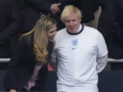 UK Prime Minister Boris Johnson (R) and his spouse Carrie (L) are seen during the UEFA EUR