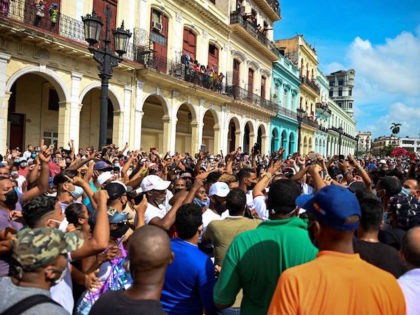 People take part in a demonstration against the government of Cuban President Miguel Diaz-Canel in Havana, on July 11, 2021. - Thousands of Cubans took part in rare protests Sunday against the communist government, marching through a town chanting "Down with the dictatorship" and "We want liberty." (Photo by YAMIL …