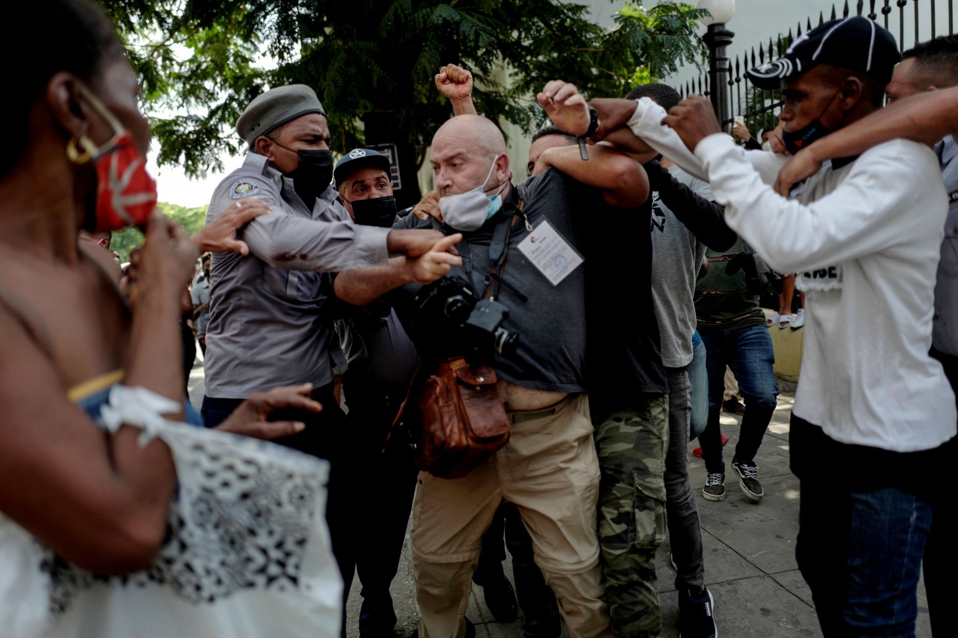 TOPSHOT - AP photographer, Spanish Ramon Espinosa, is attacked by the police while covering a demonstration against Cuban President Miguel Diaz-Canel in Havana, on July 11, 2021. - Thousands of Cubans took part in rare protests Sunday against the communist government, marching through a town chanting "Down with the dictatorship" and "We want liberty." (Photo by Adalberto ROQUE / AFP) (Photo by ADALBERTO ROQUE/AFP via Getty Images)