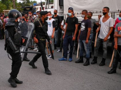 Riot police walk the streets after a demonstration against the government of President Miguel Diaz-Canel in Arroyo Naranjo Municipality, Havana on July 12, 2021. - Cuba on Monday blamed a "policy of economic suffocation" of United States for unprecedented anti-government protests, as President Joe Biden backed calls to end "decades …