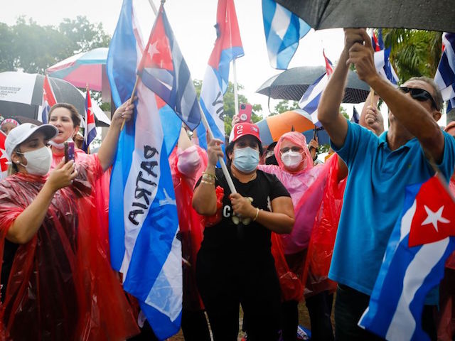 People demonstrate,carrying Cuban national flags, during a protest against the Cuban government at Tamiami Park in Miami, on July 13, 2021. - Washington warned Haitians and Cubans against trying to flee to the United States as they endure domestic unrest, saying the trip is dangerous and they would be repatriated. (Photo by Eva Marie UZCATEGUI / AFP) (Photo by EVA MARIE UZCATEGUI/AFP via Getty Images)
