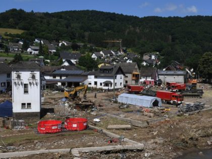 An areal view shows helpers and vehicles at work to remove debris along the river Ahr after the floods caused major damage in Schuld near Bad Neuenahr-Ahrweiler, western Germany, on July 18, 2021. - After days of extreme downpours causing devastating floods in Germany and other parts of western Europe …