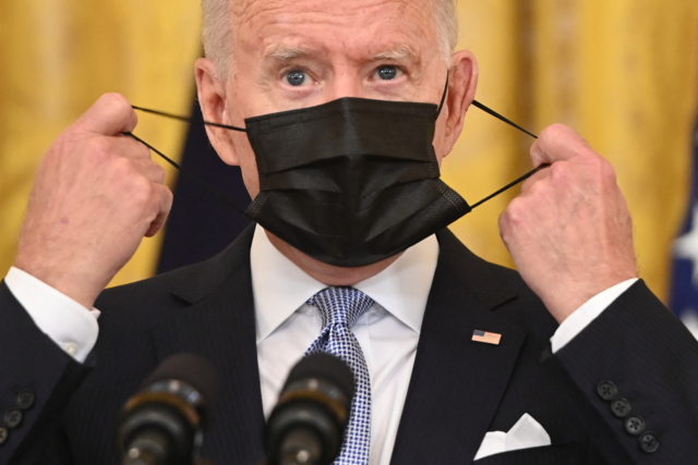 US President Joe Biden takes off his face mask before speaking about Covid vaccinations in the East Room of the White House in Washington, DC, July 29, 2021. (Photo by SAUL LOEB / AFP) (Photo by SAUL LOEB/AFP via Getty Images)