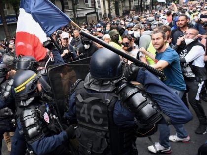 CRS riot police charge demonstrators on the sidelines of a demonstration as part of a nati
