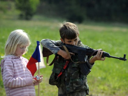 A girl holds Czech flag while young boy