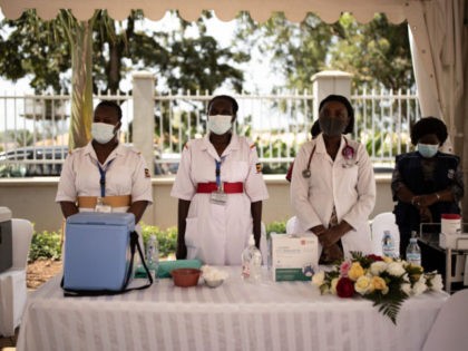 KAMPALA, UGANDA - MARCH 10: Healthcare workers take a brief moment of silence to remember colleagues who have succumbed to coronavirus on March 10, 2021 in Kampala, Uganda. Uganda began phase one of COVID-19 vaccinations today after receiving their first batch of 864,000 doses of the AstraZeneca vaccine from the …