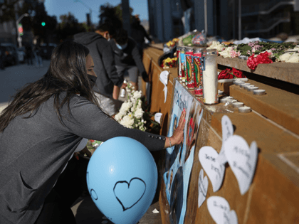 A mourner pauses in front of a memorial for the nine victims of a shooting at the Santa Clara Valley Transportation Authority (VTA) light rail yard on May 27, 2021 in San Jose, California. Nine people were killed when a VTA employee opened fire at the VTA light rail yard …