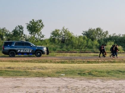 LA JOYA, TEXAS - JUNE 21: La Joya police escort immigrants to border patrol after they crossed the Rio Grande into the U.S. on June 21, 2021 in La Joya, Texas. A surge of mostly Central American immigrants crossing into the United States has challenged U.S. immigration agencies along the …