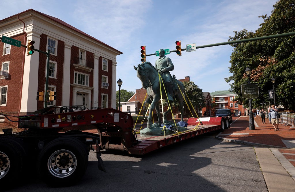 CHARLOTTESVILLE, VIRGINIA - JULY 10: A flatbed truck carries a statue of Confederate General Robert E. Lee away from the Market Street Park July 10, 2021 in Charlottesville, Virginia. Initial plans to remove the statue four years ago sparked the infamous “Unite the Right” rally where 32 year old Heather Heyer was killed. A statue of Confederate General Thomas "Stonewall" Jackson in the Charlottesville and Albemarle County Courthouse Historic District is also scheduled to be removed this weekend. (Photo by Win McNamee/Getty Images)