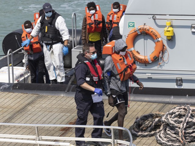 DOVER, ENGLAND - JULY 21: Migrant men arrive at Dover Port after being picked up in the English Channel by the Border Force on July 21, 2021 in Dover, England. On Monday, 430 migrants crossed the channel from France, a record for a single day. To stem the rising numbers, …