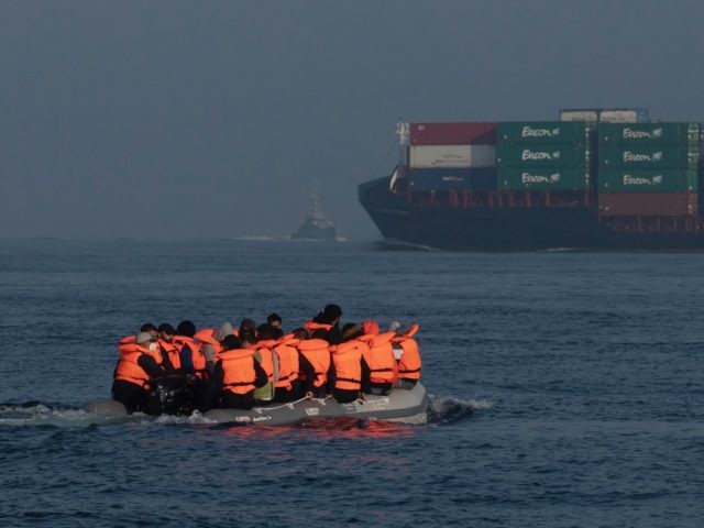 AT SEA, ENGLAND - JULY 22: The Border Force arrive to collect occupants of an inflatable c