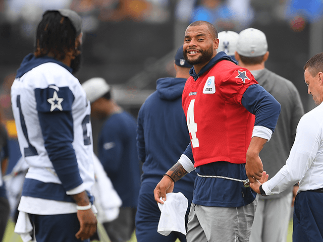Running back Ezekiel Elliott #21 and quarterback Dak Prescott #4 of the Dallas Cowboys warm up before the start of training camp at River Ridge Complex on July 24, 2021 in Oxnard, California. (Photo by Jayne Kamin-Oncea/Getty Images)
