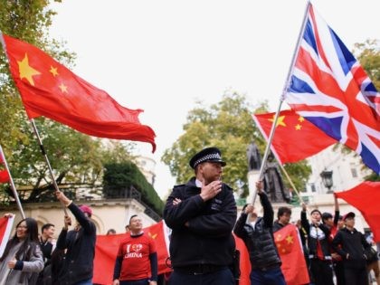 LONDON, ENGLAND - OCTOBER 20: A policeman seperates the Pro-China supporters and supporter