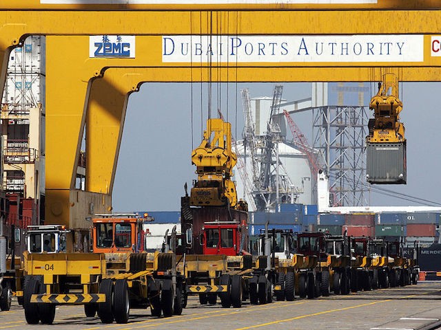 Dubai, UNITED ARAB EMIRATES: Huge cranes unload containers from a ship at Jebel Ali port i