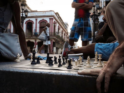 Aficionados play chess in a street of Havana, on November 8, 2016. In Havana, chess is played in schools, clubs and on the street, at the foot of the Cuban capital's crumbling colonial buildings. / AFP / ADALBERTO ROQUE / TO GO WITH AFP STORY BY HECTOR VELASCO (Photo credit …