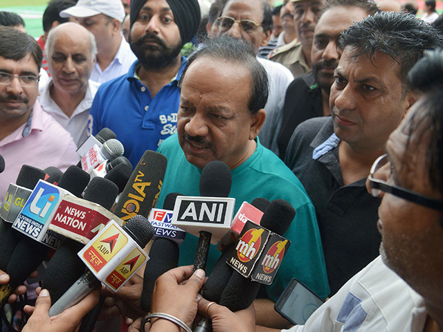 Harsh Vardhan, Indian Union Minister for Environment, Science and Technology, talks to the