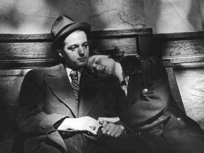 A young woman rests her head on a man's shoulder as they wait together on a bench, circa 1940. (Photo by FPG/Hulton Archive/Getty Images)