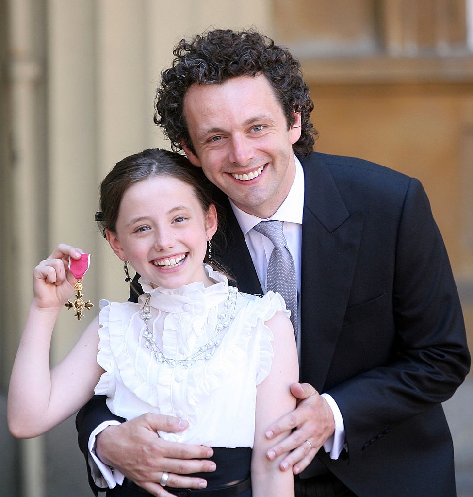 LONDON - JUNE 2: Actor Michael Sheen and daughter Lily with the OBE he received earlier from Queen Elizabeth II during investitures at Buckingham Palace on June 2, 2009 in London, England. (Photo by Lewis Whyld - WPA Pool/Getty Images)