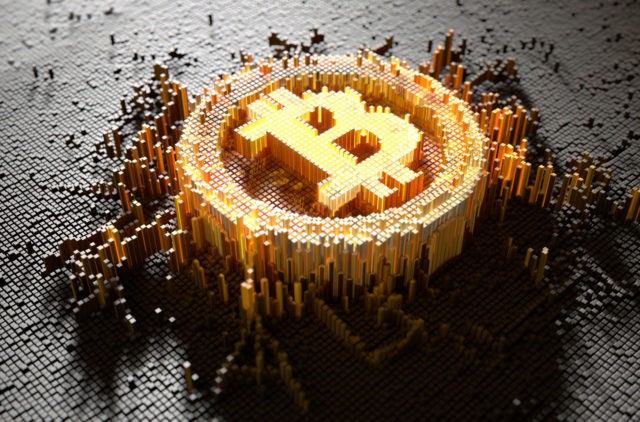 A 3D render of a microscopic closeup concept of small cubes in a random layout that build up to form the bitcoin symbol illuminated