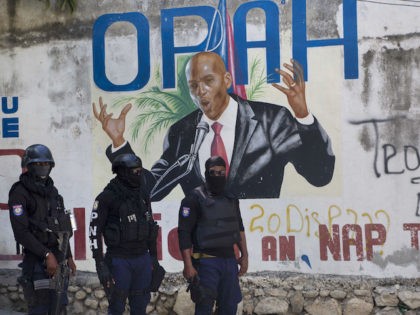 Haitian police control the area next to a painting of Haiti's President Jovenel Moise next to his private residence in Port-au-Prince, Haiti, Wednesday, July 7, 2021. Mo‘se was assassinated after a group of unidentified people attacked his private residence, the country interim prime minister said in a statement, Mo‘se's wife, …