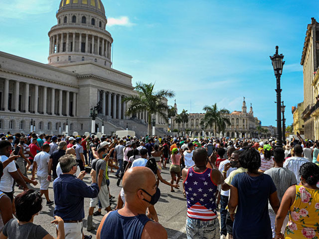 Cubans are seen outside Havana's Capitol during a demonstration against the government of Cuban President Miguel Diaz-Canel in Havana, on July 11, 2021. - Thousands of Cubans took part in rare protests Sunday against the communist government, marching through a town chanting "Down with the dictatorship" and "We want liberty." …