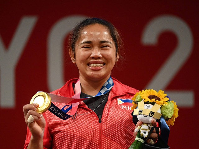 Gold medallist Philippines' Hidilyn Diaz stand on the podium for the victory ceremony of the women's 55kg weightlifting competition during the Tokyo 2020 Olympic Games at the Tokyo International Forum in Tokyo on July 26, 2021. (Photo by Vincenzo PINTO / AFP) (Photo by VINCENZO PINTO/AFP via Getty Images)