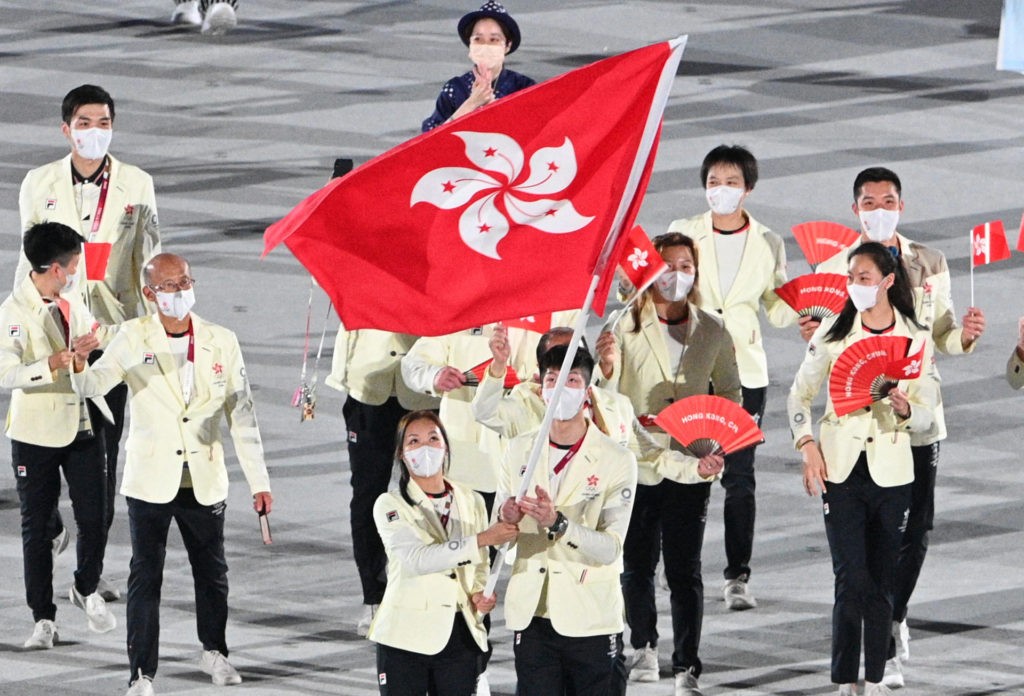Hong Kong's flag bearer Ying Suet Tse and Hong Kong's flag bearer Cheung Ka-long and their delegation parade during the opening ceremony of the Tokyo 2020 Olympic Games, at the Olympic Stadium, in Tokyo, on July 23, 2021. (Photo by Martin BUREAU / AFP) (Photo by MARTIN BUREAU/AFP via Getty Images)