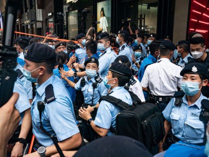 HONG KONG, CHINA - JULY 1 : Police officers use tape to cordon off areas on the 24th anniv