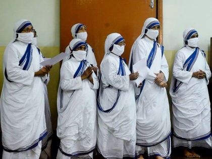 Roman Catholic nuns of the Missionaries of Charity order pray at the tomb of Mother Teresa